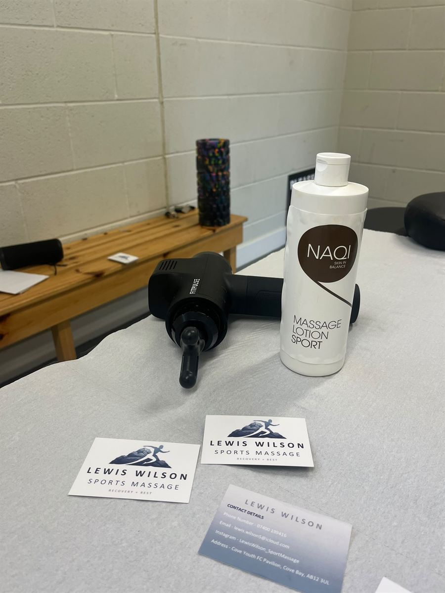 Massage gun, sports massage lotion and Lewis Wilson business cards